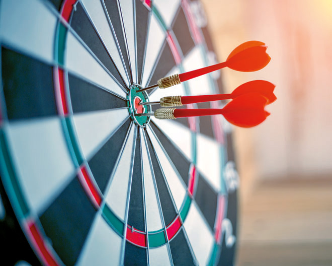 Red dart arrow hitting in the target center of dartboard busines